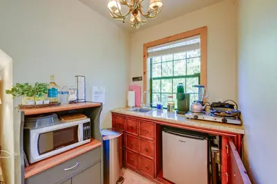 a kitchen with a counter with a microwave and a window at Lakeside Bear Lodge Studio 9 Mi to Bass Lake! in Bass Lake Annex