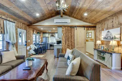 a living room with a couch and a table at 9 Mi to Bass Lake Cabin with Fire Pit in Wishon! in Bass Lake Annex