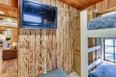 a tiny house with a tv and a bunk bed at 9 Mi to Bass Lake Cabin with Fire Pit in Wishon! in Bass Lake Annex