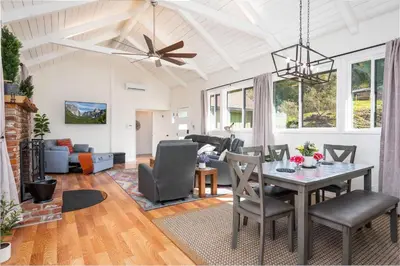 a dining room and living room with a table and chairs at Buckeye Bungalow w hot tub/firepit/views Pet Friendly in Oakhurst