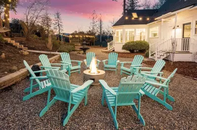 a group of chairs with a candle in a yard at Yosemite Country House sleeps 20 w/ hot tub, firepit, bonus studio in Oakhurst