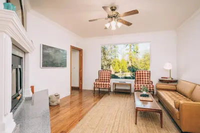 a living room with a couch and a table at Yosemite Country House sleeps 20 w/ hot tub, firepit, bonus studio in Oakhurst