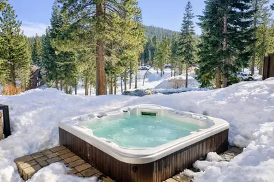 a hot tub in the snow at Luxury Northstar Home| hot tub| walk to ski lifts in Truckee