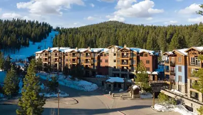 an aerial view of a resort with a river and trees at Luxury Northstar Home| hot tub| walk to ski lifts in Truckee