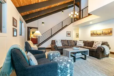 a living room with two couches and a table at North Lake Tahoe Cabin and Hot Tub in Tahoe City