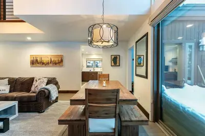 a living room with a table and a couch at North Lake Tahoe Cabin and Hot Tub in Tahoe City