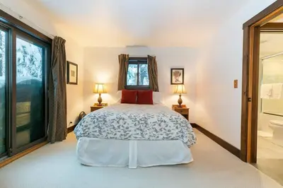 a bedroom with a bed and a window at North Lake Tahoe Cabin and Hot Tub in Tahoe City