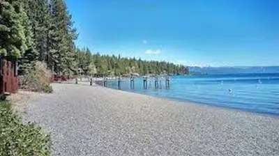 a beach with trees and a body of water at North Lake Tahoe Cabin and Hot Tub in Tahoe City
