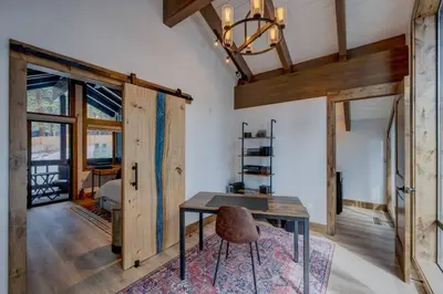 a dining room with a table and a chair at Extra Spacious 2BR Cabin w Office and Outdoor Deck in Incline Village
