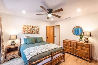 a bedroom with a bed and a ceiling fan at Red Rock Falls Cabin, 8 miles from Yosemite South Gate, with trailhead, Game Room and HotTub in Oakhurst