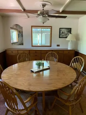 a dining room table with chairs and a wooden table at Harte's Desire Cabin - Lake, A/C, Arcade + in Twain Harte