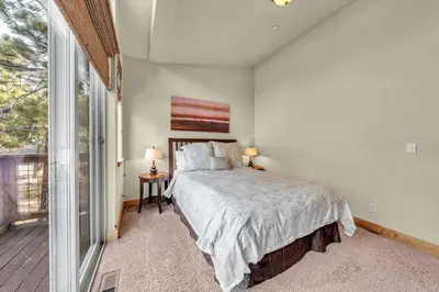 a bedroom with a bed and a large window at Sunny Daze Cabin Luxurious 4BDR with Stunning Views in Kings Beach