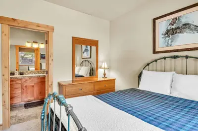 a bedroom with a bed and a large mirror at Sunny Daze Cabin Luxurious 4BDR with Stunning Views in Kings Beach