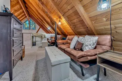 a living room with a couch and a table at The Rigi Chalet HOA Beach Access Close to town in Tahoe City