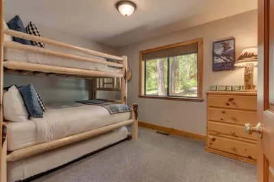 a bedroom with two bunk beds and a window at Modern 3BR Tahoe Cabin with Hot Tub in Tahoe City