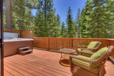 a deck with a hot tub and chairs and a table at Modern 3BR Tahoe Cabin with Hot Tub in Tahoe City