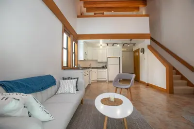 a living room with a white couch and a table at One BDR at Northstar Walk to Village in Truckee