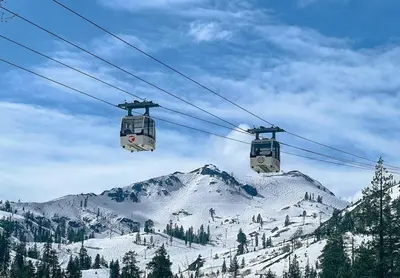 two gondolas on a ski lift over a snow covered mountain at One BDR at Northstar Walk to Village in Truckee
