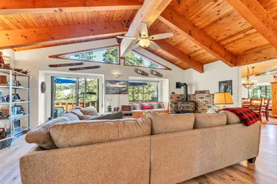 a living room with a couch and a ceiling fan at The Big Bear Chalet Private Hot Tub in Carnelian Bay