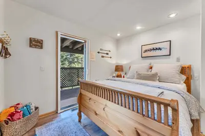 a bedroom with a large bed and a window at The Big Bear Chalet Private Hot Tub in Carnelian Bay