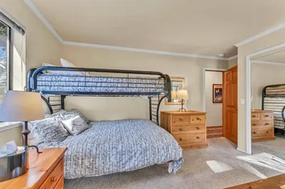 a bedroom with a bed and a desk with two lamps at The Big Bear Chalet Private Hot Tub in Carnelian Bay