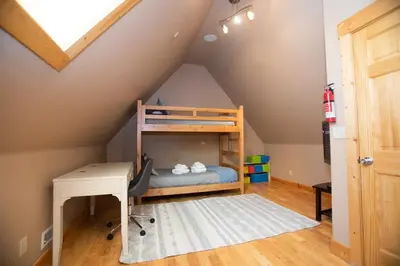 a room with a desk and a bunk bed in a attic at The Tallac Lodge Hot Tub Walk 2 Beach in Carnelian Bay