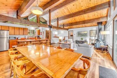 a kitchen and living room with a wooden table and chairs at Carnelian Bay Retreat with Deck & Bonus Room in Carnelian Bay