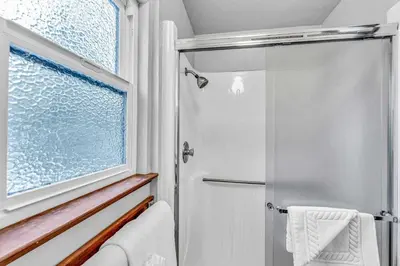 a bathroom with a shower and a window at Carnelian Bay Retreat with Deck & Bonus Room in Carnelian Bay