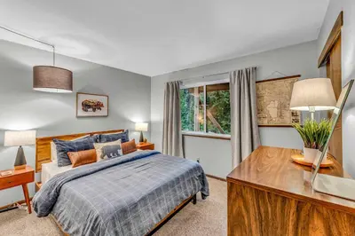 a bedroom with a bed and a desk and a window at Carnelian Bay Retreat with Deck & Bonus Room in Carnelian Bay