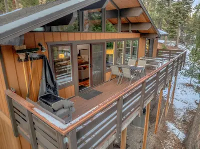 a house with a large deck with a grill at Carnelian Bay Retreat with Deck & Bonus Room in Carnelian Bay