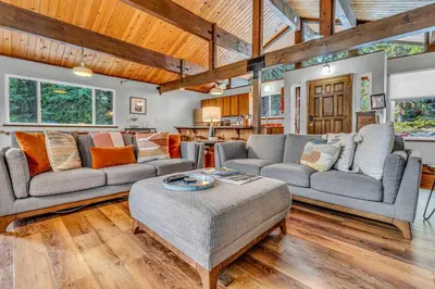 a living room with two couches and a table at Carnelian Bay Retreat with Deck & Bonus Room in Carnelian Bay