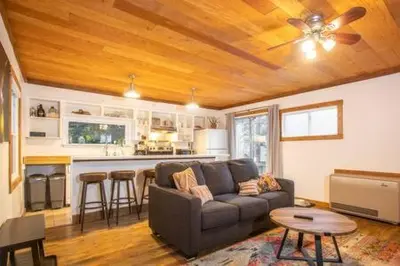a living room with a couch and a kitchen at Mt Airy Cottage Walk to Beach in Tahoe Vista