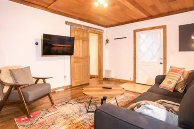a living room with a couch and a table at Mt Airy Cottage Walk to Beach in Tahoe Vista
