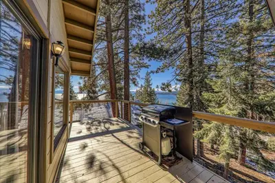 a grill on the deck of a house at Tahoe Vista Retreat with Lake View Walk to beach in Tahoe Vista