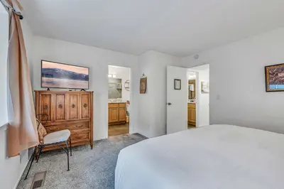 a white bedroom with a bed and a dresser at Modern 3BD -Walk to Lake & Beach in Tahoe City