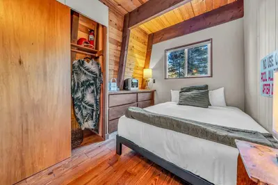 a bedroom with a bed in a wooden cabin at The Haus of Pine A Vintage Tahoe Cabin in Tahoe City