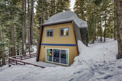 a tiny house in the woods in the snow at The Haus of Pine A Vintage Tahoe Cabin in Tahoe City
