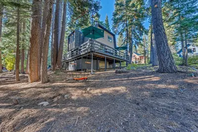 a house in the woods with trees in the foreground at The Haus of Pine A Vintage Tahoe Cabin in Tahoe City