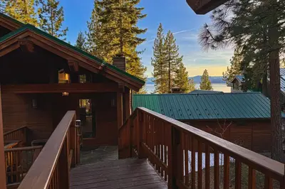 a wooden staircase leading to a house with a green roof at Lakeview Hideaway in Kings Beach