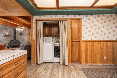 a kitchen with a washer and dryer at Toste Cabin- Spacious 3BR Cabin in East Village! in Shaver Lake