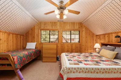 a bedroom with two beds and a ceiling fan at Toste Cabin- Spacious 3BR Cabin in East Village! in Shaver Lake