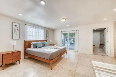 a bedroom with a bed and a table and a window at Fig Garden 4BR House W Pool in Fresno