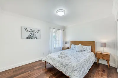a white bedroom with a bed and a window at Fig Garden 4BR House W Pool in Fresno