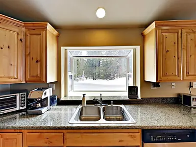 a kitchen with a sink and a window at Black Bear Cabin in South Lake Tahoe