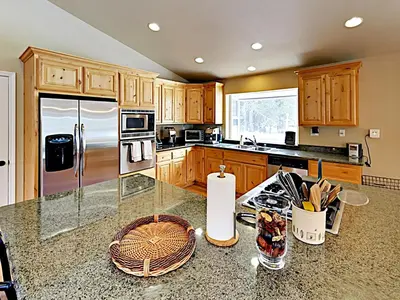 a kitchen with wooden cabinets and a glass counter top at Black Bear Cabin in South Lake Tahoe