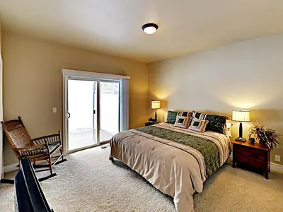 a bedroom with a bed and a sliding glass door at Black Bear Cabin in South Lake Tahoe