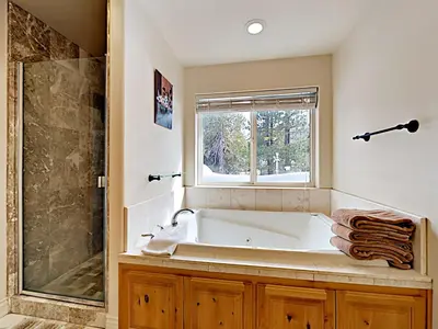 a bathroom with a bath tub and a window at Black Bear Cabin in South Lake Tahoe
