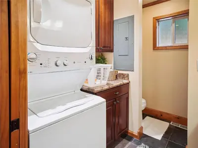 a bathroom with a sink and a washer at High Sierra Escape - Cozy, Spacious Mountain Home in South Lake Tahoe