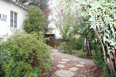 a garden with a walkway in front of a house at The Bonnie Inn Unit 1 in San Andreas