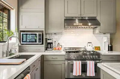 a kitchen with stainless steel appliances and white cabinets at Private Ski, Lake & Golf Chalet! Walk to Lake in Tahoe Vista